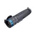 Pulsar Telos XG50 monokular używany przez myśliwego w kamuflażu podczas obserwacji terenu leśnego, obok widoczne logo marki.